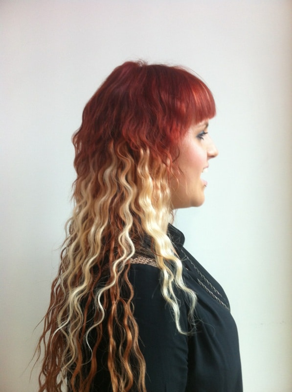 woman with curly hair with blonde, red and orange colouring