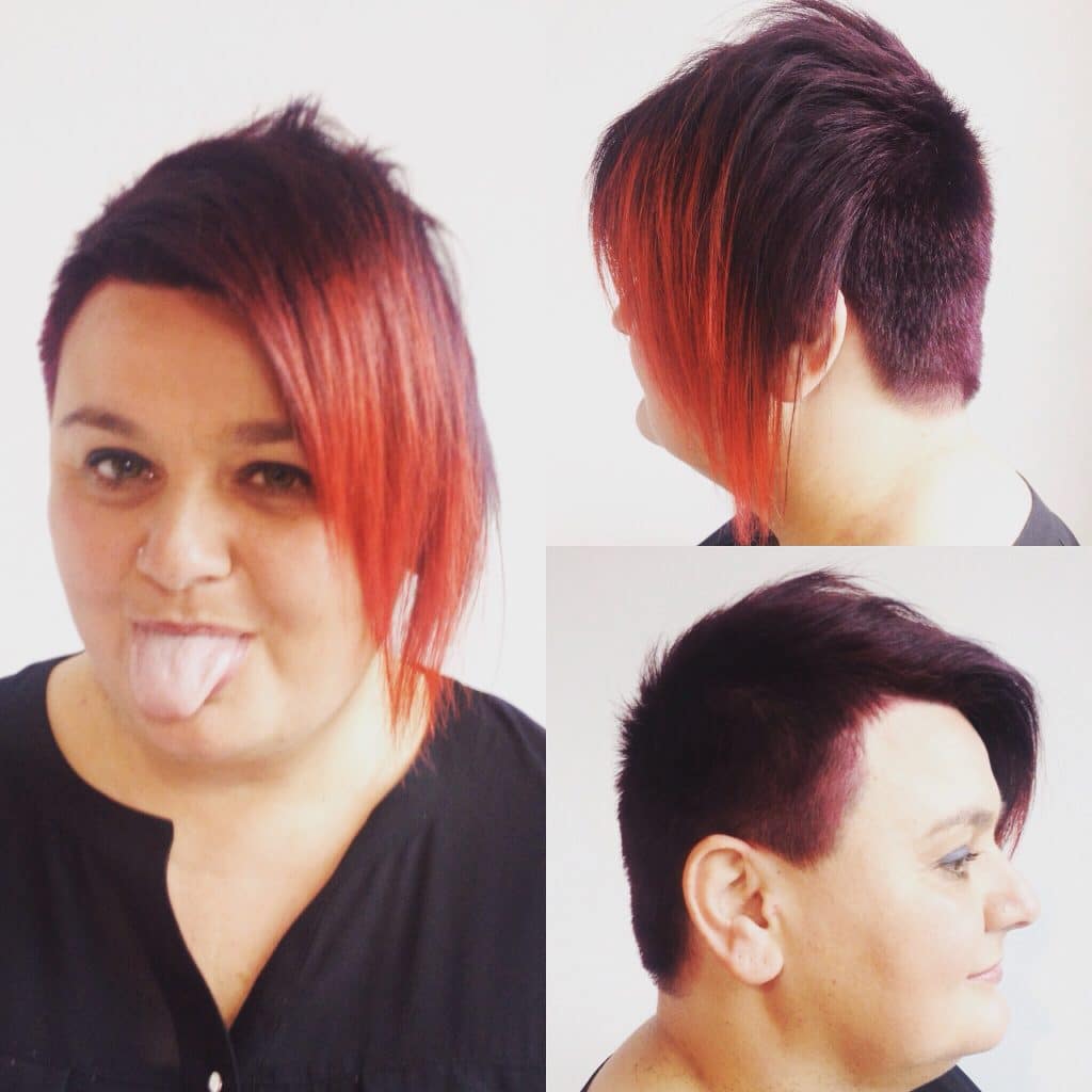 woman with short red hair and a long fringe