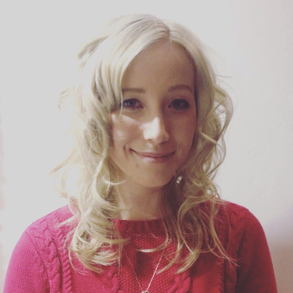 woman smiling with blonde and curly hair