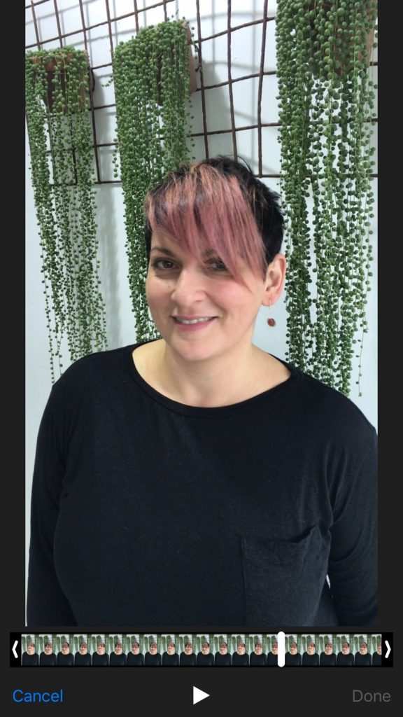 woman with short hairstyle smiling and pink fringe