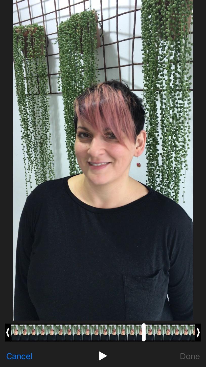 woman with short hairstyle smiling and pink fringe