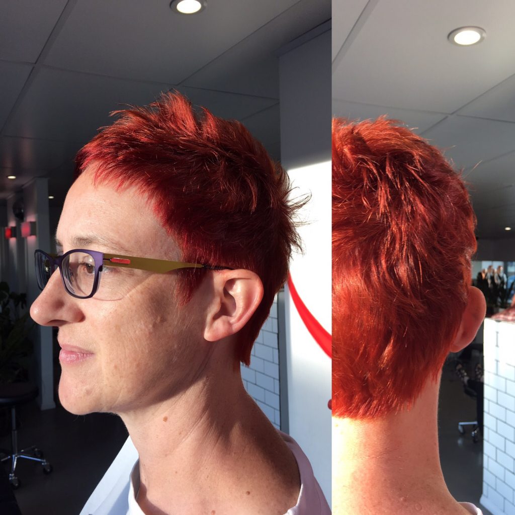 woman wearing glasses with short red hair