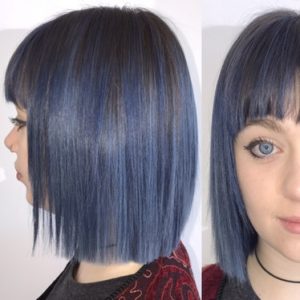 woman with short blue hair smiling