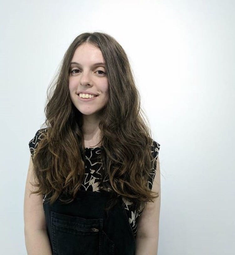 woman with long hair smiling