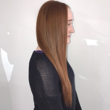 woman standing sideways with long hair