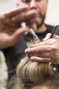 hairdresser cutting client's hair