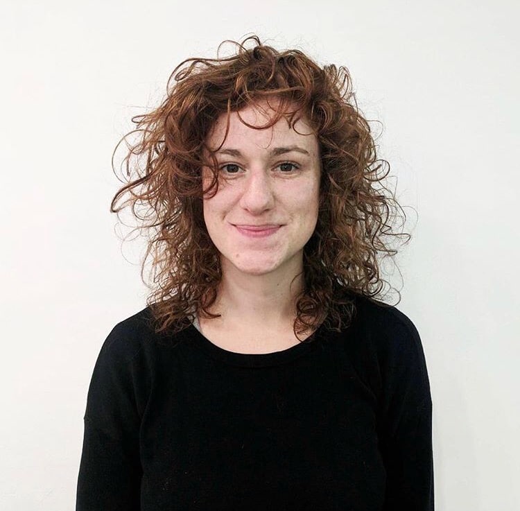 woman smiling with curly hair