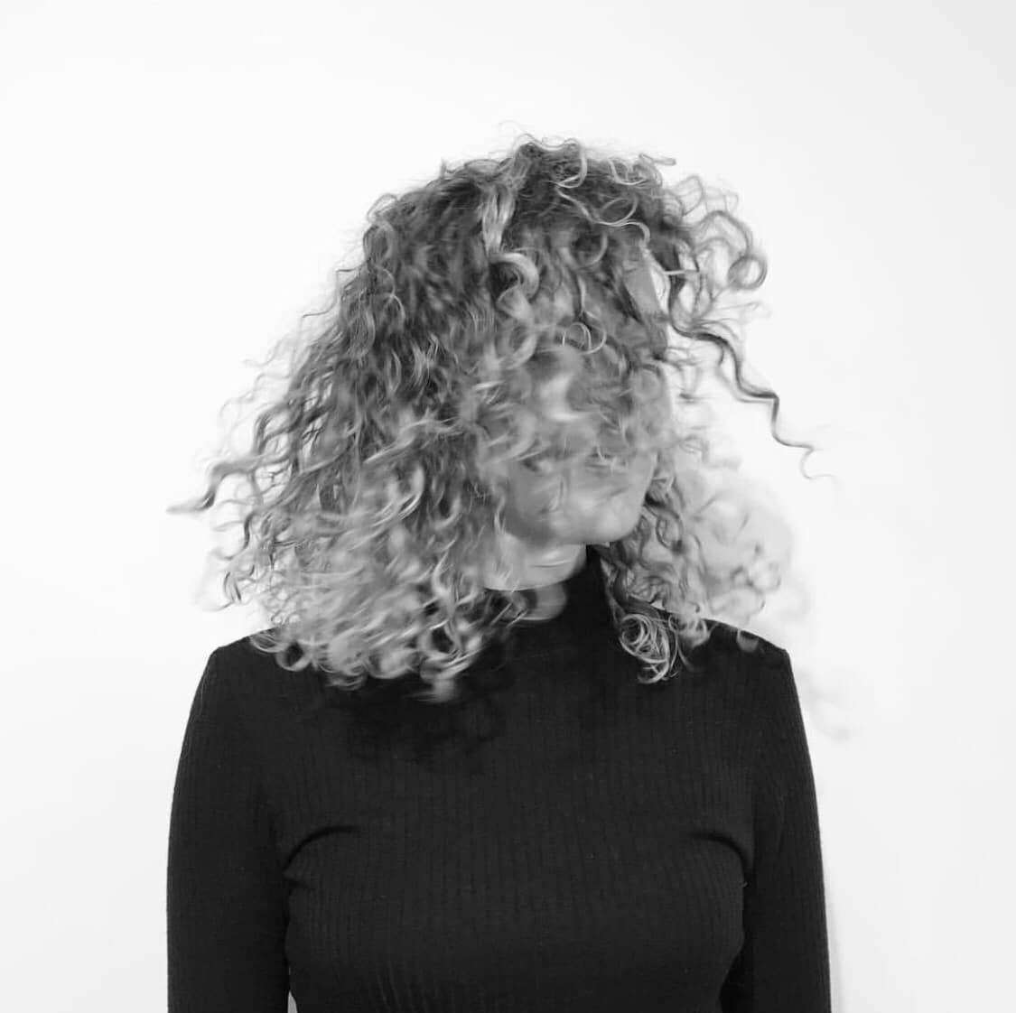 black and white photo of woman with curly hair