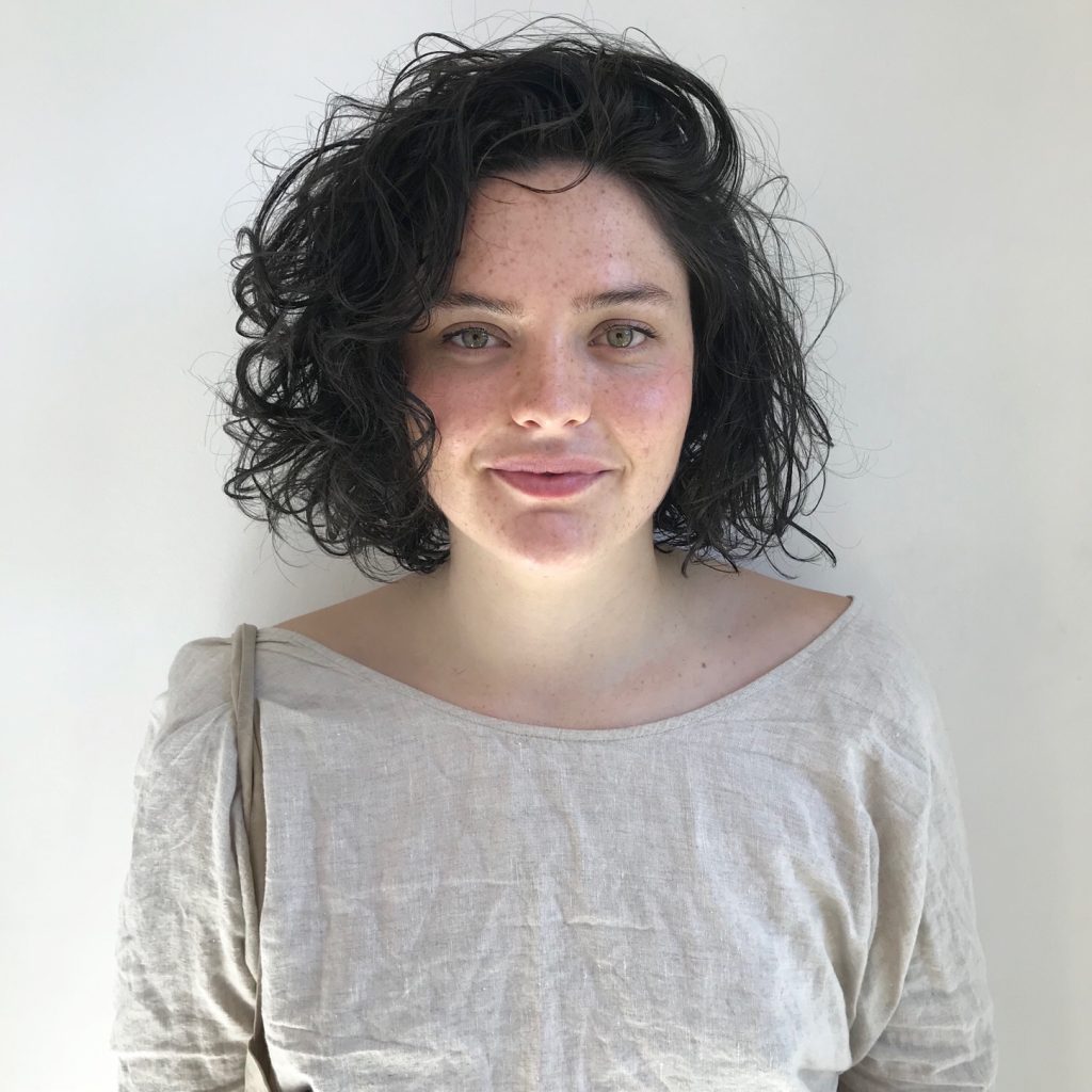 woman smiling with short and curly hair