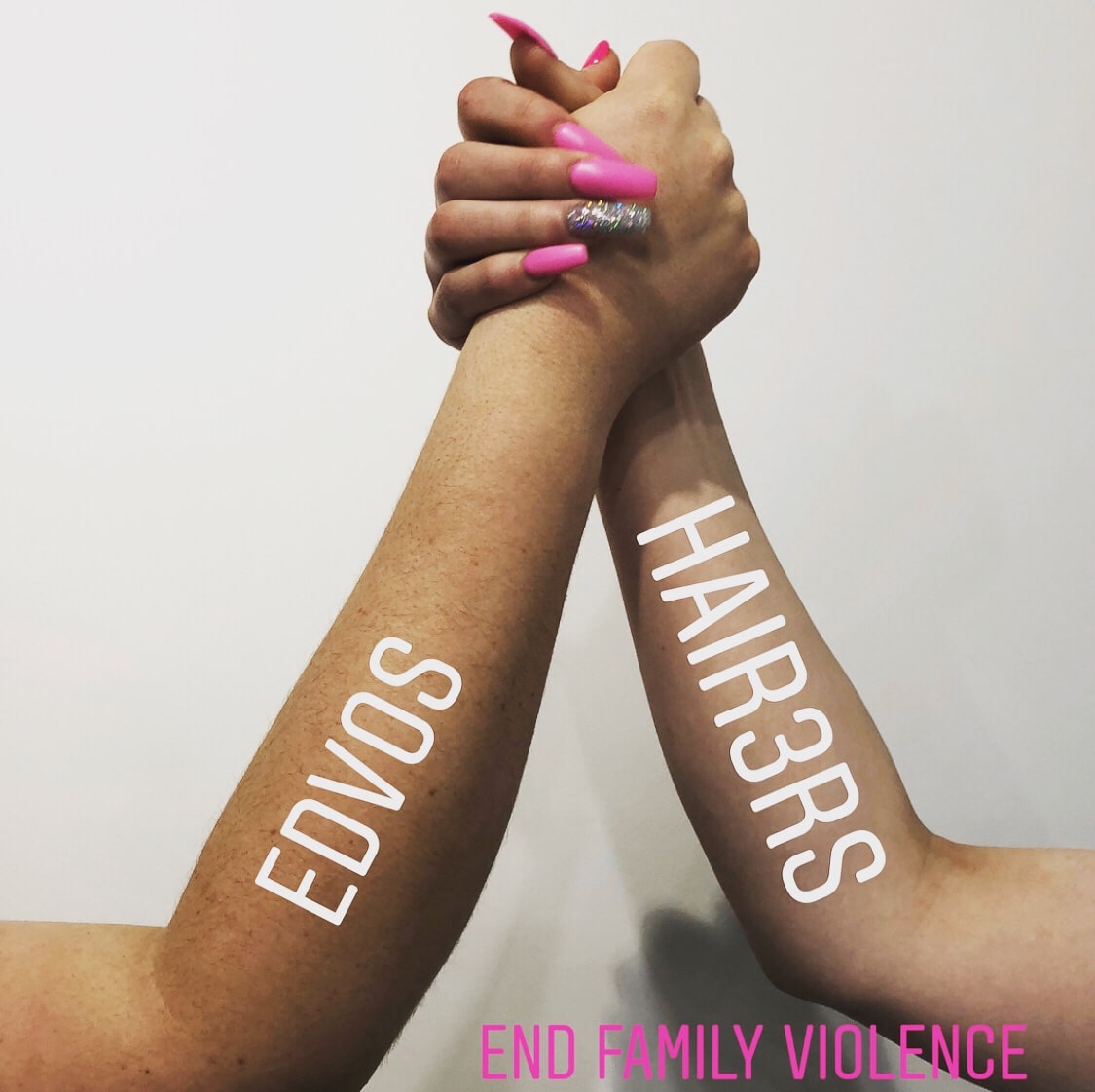 two hands together with captions on arms that says endcos, hair 3r's and end family violence