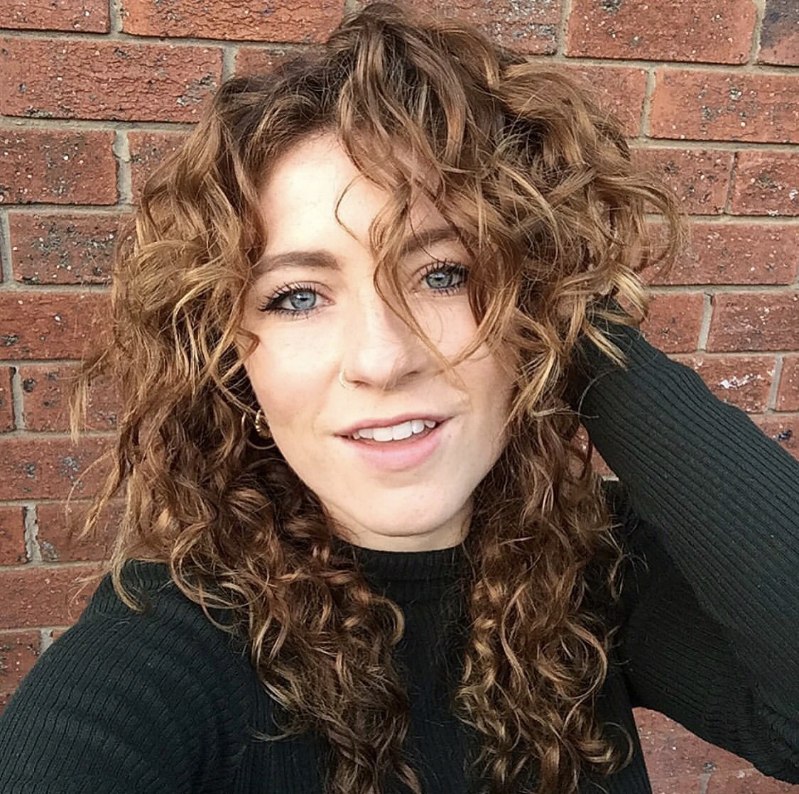 woman smiling with curly hair