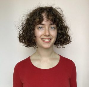 woman with curly hair smiling