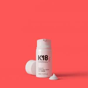 K18 leave-in molecular repair hair mask on a red background
