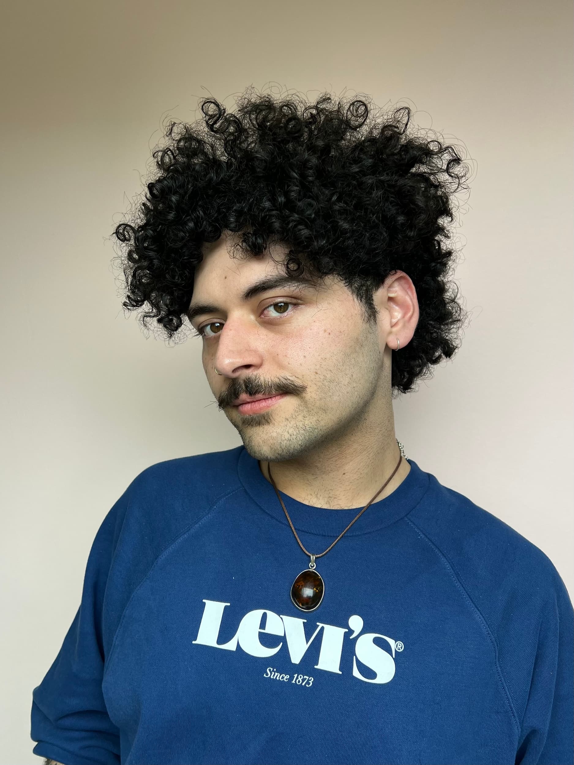 Short curly hairstyle for men by Delilah